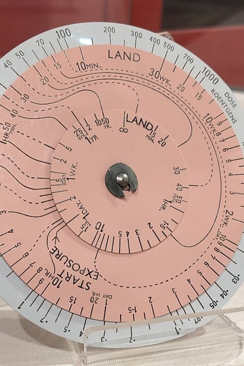 A circular instrument with an inner dial showing distance and effects of radiation